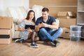 Young beautiful couple sitting on floor in their new flat Royalty Free Stock Photo