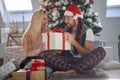 A young couple sitting at home excited about Xmas presents. Christmas, relationship, love, together Royalty Free Stock Photo