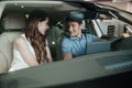 Young couple sitting inside new car Royalty Free Stock Photo