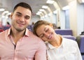 Young couple sitting in modern train Royalty Free Stock Photo