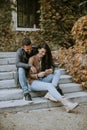 Young couple sitting on outdoor stairs on a autumn day Royalty Free Stock Photo