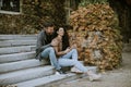 Young couple sitting on outdoor stairs on a autumn day Royalty Free Stock Photo