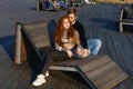 young couple are sitting in the park on a wooden bench hugging Royalty Free Stock Photo