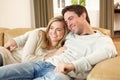 Young couple sitting and relaxing on sofa Royalty Free Stock Photo