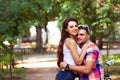 Young couple sitting on a scooter and talking in a city park Royalty Free Stock Photo