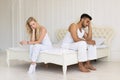 Young Couple Sitting Separate On Bed, Having Conflict Relationships Problem, Sad Negative Emotions Hispanic Royalty Free Stock Photo