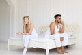 Young Couple Sitting Separate On Bed, Having Conflict Relationships Problem, Sad Negative Emotions Hispanic Man And Royalty Free Stock Photo