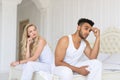 Young Couple Sitting Separate On Bed, Having Conflict Relationships Problem, Sad Negative Emotions Hispanic Man And Royalty Free Stock Photo