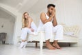 Young Couple Sitting Separate On Bed, Having Conflict Relationships Problem, Sad Negative Emotions Hispanic Man And Royalty Free Stock Photo