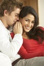 Young Couple Sitting On Sofa Royalty Free Stock Photo