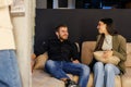 Young couple sitting sofa talking having conversation Royalty Free Stock Photo