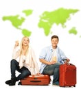Young couple sitting on suitcases