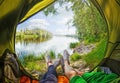 Young couple sitting in the tent while looking on the Desna river