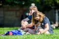 A young couple sitting with their dog in the park at a dog show