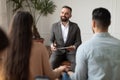 Young couple sitting at therapy session with male therapist Royalty Free Stock Photo