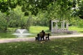 Young couple sitting together on park bench Royalty Free Stock Photo