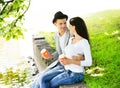 Young couple sitting together on the riverside with coffee Royalty Free Stock Photo