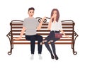 Young couple sitting together on street bench and talking. Happy man and woman in love isolated on white background. Boy Royalty Free Stock Photo