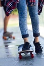 Young couple skateboarding in the street. Royalty Free Stock Photo