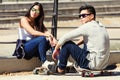 Young couple skateboarding in the street. Royalty Free Stock Photo