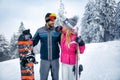 Couple skiing and snowboarding enjoying in snowy mountains Royalty Free Stock Photo