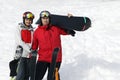A young couple with skis in helmet and mask on the background of mountains; toned Royalty Free Stock Photo