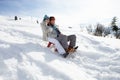 Young Couple Sledding