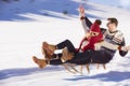 Young Couple Sledding And Enjoying On Sunny Winter Day Royalty Free Stock Photo