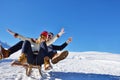 Young Couple Sledding And Enjoying On Sunny Winter Day Royalty Free Stock Photo