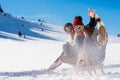 Young Couple Sledding And Enjoying On Sunny Winter Day Royalty Free Stock Photo