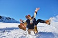 Young Couple Sledding And Enjoying On Sunny Winter Day Royalty Free Stock Photo