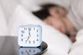 Young couple sleeping in bed next to an alarm clock Royalty Free Stock Photo
