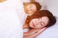 Couple sleeping on a comfortable bed in bedroom at home Royalty Free Stock Photo