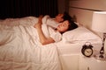 Couple sleeping on a comfortable bed in bedroom at night Royalty Free Stock Photo