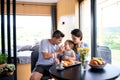 Young couple with small daughter indoors, weekend away in container house in countryside.