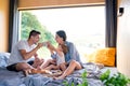 Young couple with small daughter indoors, weekend away in container house in countryside.