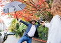 Young couple with smartphone making video for social media outdoors on street. Royalty Free Stock Photo