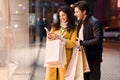 Young couple with smartphone near shopping mall Royalty Free Stock Photo