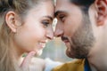 A young couple smile and touching foreheads. Autumn wedding ceremony outdoors. Bride and groom look at each other with