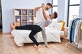 Young couple smiling confident dancing at bedrooom