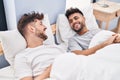 Young couple smiling confident lying on bed at bedrooom