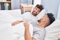 Young couple smiling confident lying on bed at bedrooom