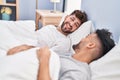 Young couple smiling confident lying on bed at bedrooom