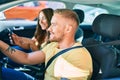 Young couple smiling happy driving car and using gps navigator smartphone Royalty Free Stock Photo