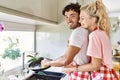 Young couple smiling happy and hugging washing dishes at kitchen Royalty Free Stock Photo