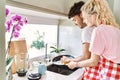 Young couple smiling happy and hugging washing dishes at kitchen Royalty Free Stock Photo