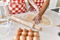 Young couple smiling happy kneading dough with hands at kitchen Royalty Free Stock Photo