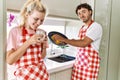 Young couple smiling happy washing dishes and drinking coffe at kitchen Royalty Free Stock Photo