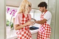 Young couple smiling happy washing dishes and drinking coffe at kitchen Royalty Free Stock Photo