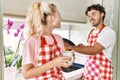 Young couple smiling happy washing dishes and drinking coffe at kitchen Royalty Free Stock Photo